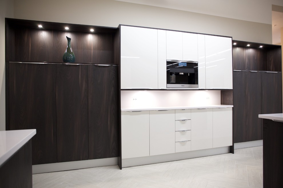 Expansive contemporary l-shaped open plan kitchen in Miami with a single-bowl sink, flat-panel cabinets, dark wood cabinets, quartz benchtops, white splashback, panelled appliances, porcelain floors and with island.