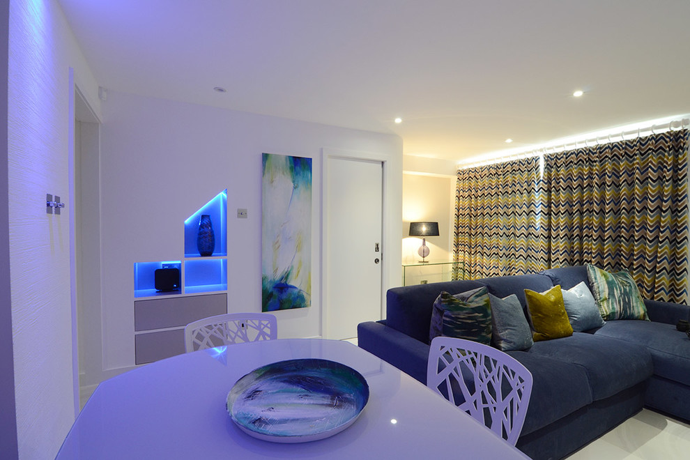 This is an example of a medium sized contemporary formal open plan living room in London with multi-coloured walls, marble flooring and a wall mounted tv.