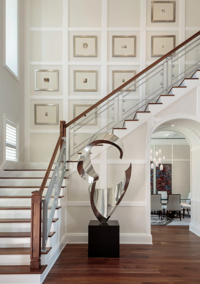 Large mediterranean wood l-shaped staircase in Miami with wood risers and mixed railing.