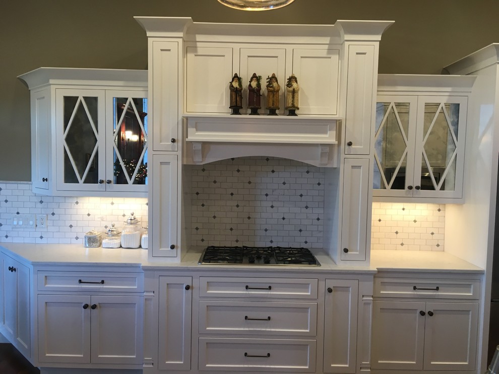 Inspiration for a large transitional galley dark wood floor and brown floor open concept kitchen remodel with an undermount sink, beaded inset cabinets, white cabinets, quartz countertops, white backsplash, marble backsplash and stainless steel appliances