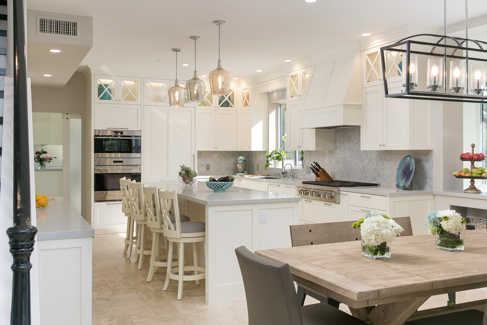 Design ideas for a transitional u-shaped eat-in kitchen in San Diego with shaker cabinets, white cabinets, with island, beige floor and grey benchtop.