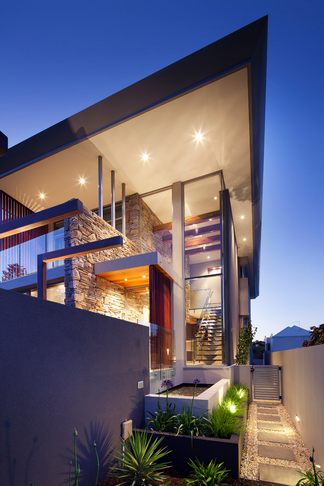 Photo of a contemporary two-storey grey exterior in Perth with stone veneer and a flat roof.
