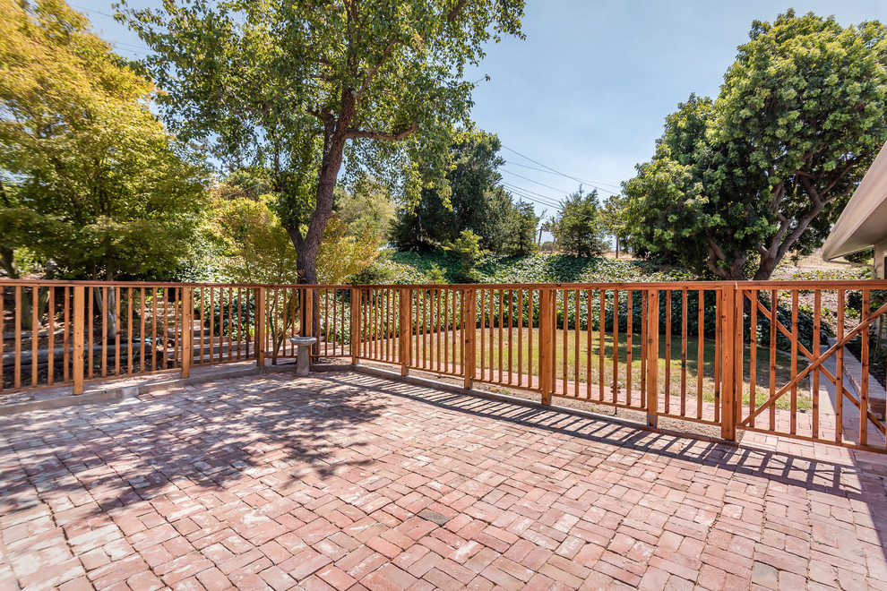Mid-sized arts and crafts front yard patio in San Luis Obispo with brick pavers and no cover.