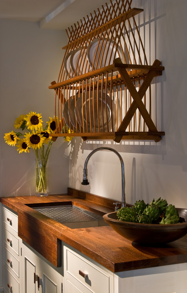 Transitional u-shaped eat-in kitchen photo in Chicago with an undermount sink, flat-panel cabinets, white cabinets, wood countertops and paneled appliances