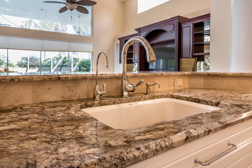 Example of a large transitional u-shaped marble floor kitchen design in Miami with a single-bowl sink, shaker cabinets, white cabinets, granite countertops, stainless steel appliances and an island