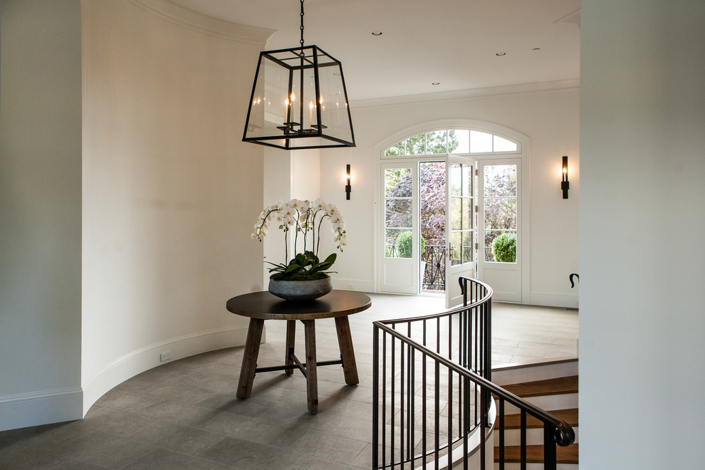 This is an example of a mid-sized traditional hallway in Portland with white walls and porcelain floors.