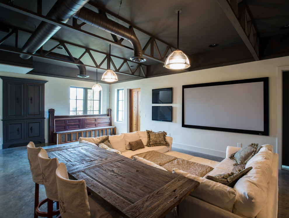 Inspiration for a country home theatre in Nashville with concrete floors, a projector screen and grey floor.