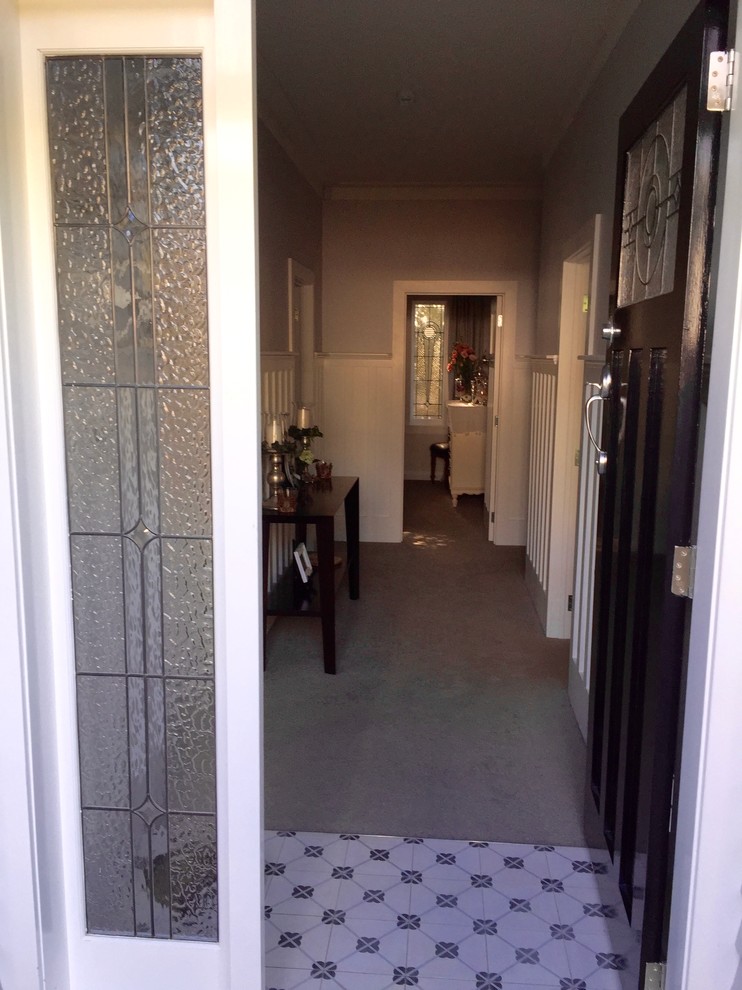 Design ideas for a traditional hallway in Auckland With Grey Walls and Concrete Floors.