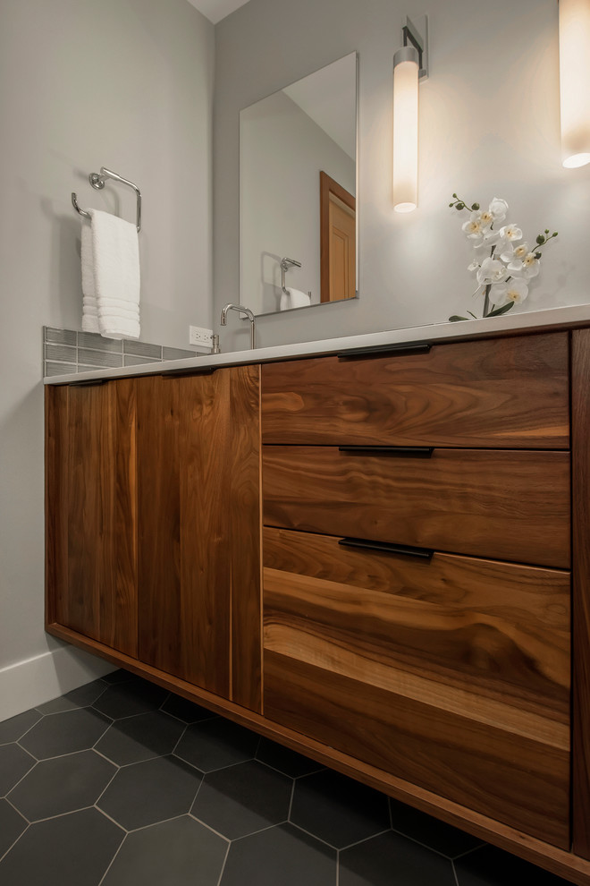 Inspiration for a mid-sized midcentury master bathroom in Seattle with flat-panel cabinets, brown cabinets, a curbless shower, a two-piece toilet, ceramic tile, grey walls, porcelain floors, an undermount sink, engineered quartz benchtops, a sliding shower screen, white benchtops, gray tile and grey floor.