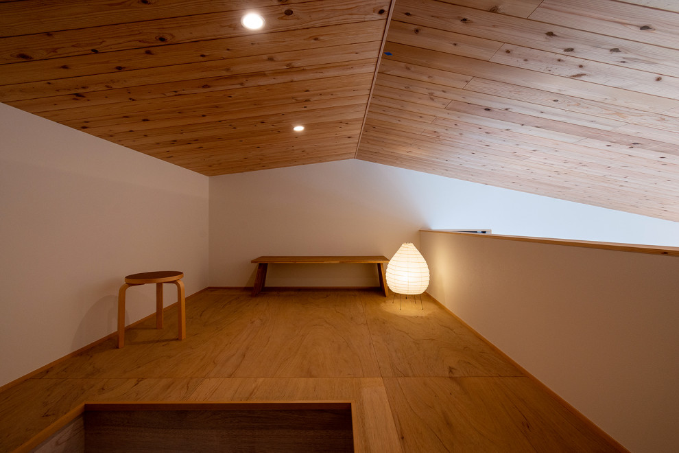 Immagine di un piccolo ufficio nordico con pareti bianche, nessun camino, scrivania autoportante, soffitto in legno e carta da parati