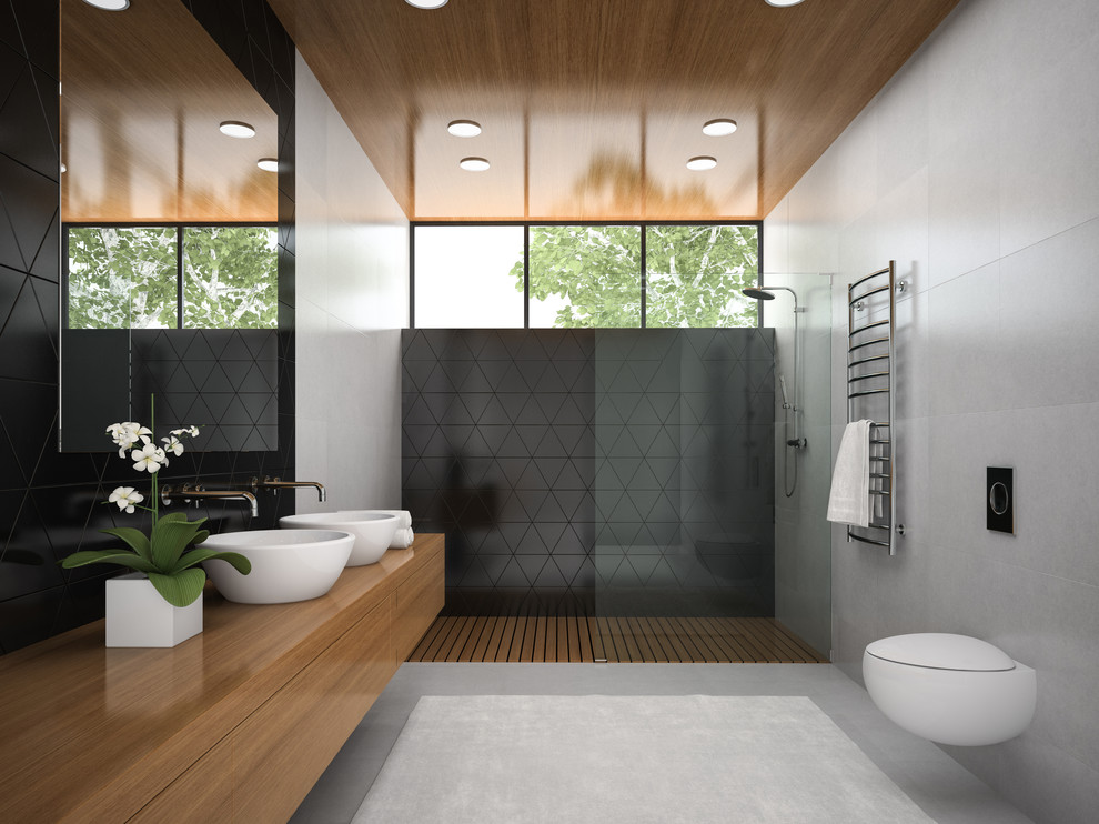 Large contemporary master bathroom in Melbourne with dark wood cabinets, an open shower, a one-piece toilet, gray tile, porcelain tile, grey walls, porcelain floors, a vessel sink, grey floor, an open shower, flat-panel cabinets and wood benchtops.