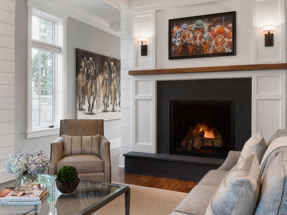 Inspiration for a large traditional formal open concept living room with grey walls, medium hardwood floors, a standard fireplace, a stone fireplace surround, no tv, brown floor and planked wall panelling.