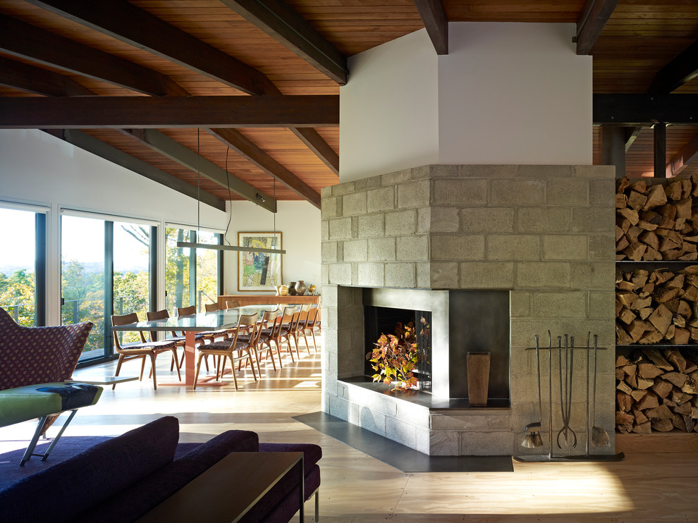Inspiration for a midcentury dining room in Bridgeport with a stone fireplace surround.