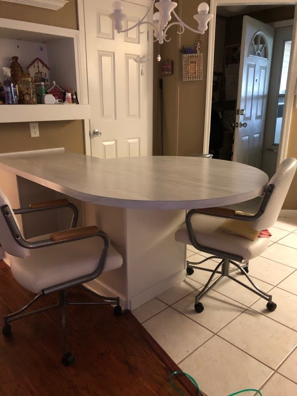 Example of a small galley eat-in kitchen design with laminate countertops and no island
