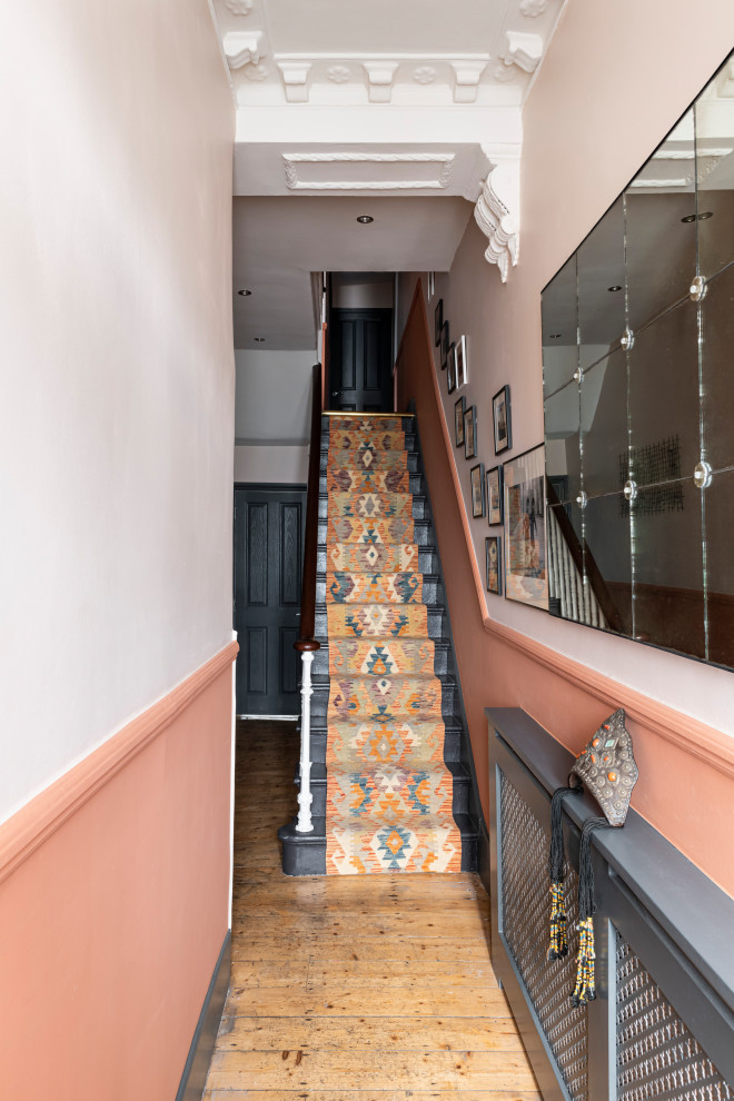 Example of a small eclectic carpeted staircase design in London