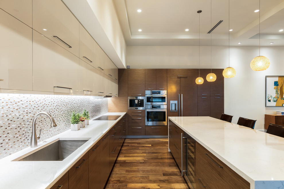 Design ideas for a large contemporary l-shaped open plan kitchen in Tampa with an undermount sink, flat-panel cabinets, medium wood cabinets, quartz benchtops, multi-coloured splashback, mosaic tile splashback, stainless steel appliances, medium hardwood floors, with island and brown floor.
