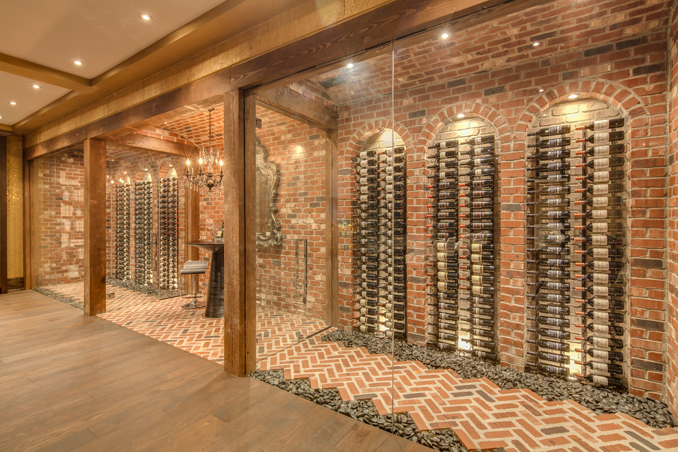 Design ideas for a mediterranean wine cellar in Vancouver with brick floors, storage racks and orange floor.