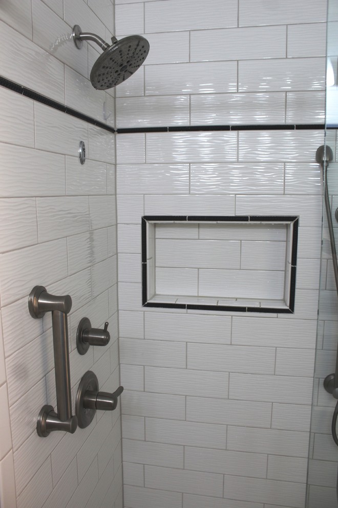 Inspiration for a small transitional master bathroom in Detroit with recessed-panel cabinets, white cabinets, an open shower, a two-piece toilet, white tile, grey walls, mosaic tile floors, a drop-in sink, engineered quartz benchtops, white floor, a sliding shower screen and black benchtops.