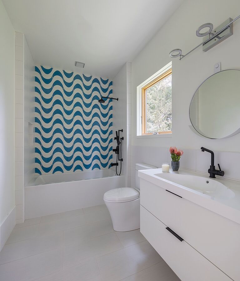 Design ideas for a mid-sized modern 3/4 bathroom in San Francisco with flat-panel cabinets, medium wood cabinets, an alcove tub, a shower/bathtub combo, a one-piece toilet, blue tile, cement tile, yellow walls, porcelain floors, an integrated sink, terrazzo benchtops and a shower curtain.