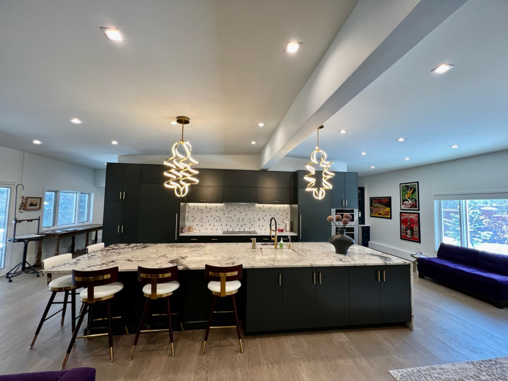 Design ideas for an expansive modern single-wall eat-in kitchen in Denver with an undermount sink, flat-panel cabinets, grey cabinets, granite benchtops, white splashback, mosaic tile splashback, panelled appliances, light hardwood floors, with island, grey floor, white benchtop and exposed beam.