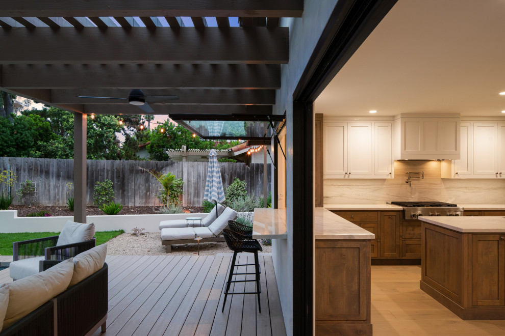 Inspiration for a mid-sized transitional backyard rectangular natural pool landscaping remodel in San Diego with decking