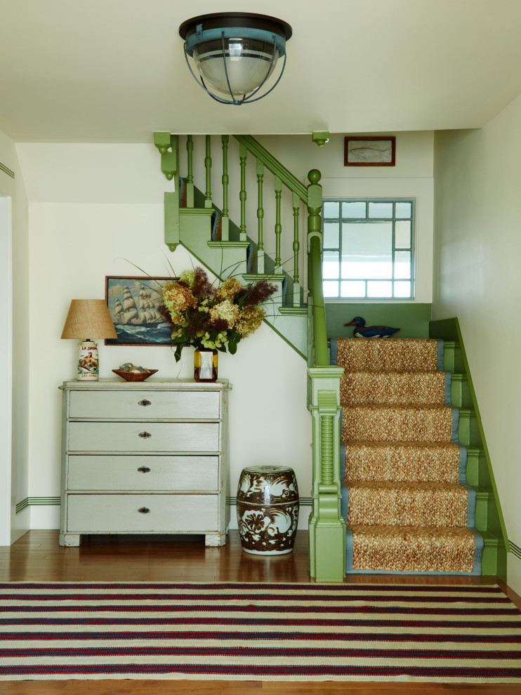 Beach style painted l-shaped wood railing staircase photo in Boston with painted risers