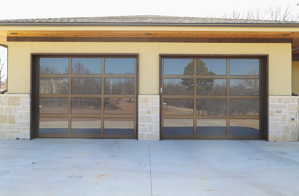 Lake House Dream - Frosted glass overhead doors with stone wainscoating and stucco exterior.