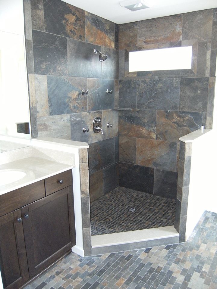 Example of a large transitional master multicolored tile and stone tile slate floor alcove shower design in New York with recessed-panel cabinets, dark wood cabinets, a two-piece toilet, white walls, an undermount sink and quartz countertops