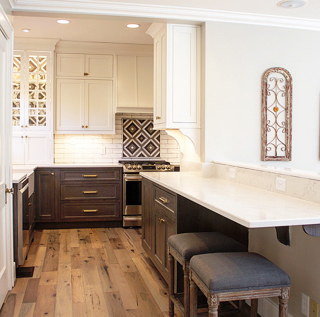 Kitchen pantry - mid-sized transitional l-shaped light wood floor and brown floor kitchen pantry idea with a farmhouse sink, flat-panel cabinets, dark wood cabinets, quartz countertops, white backsplash, stainless steel appliances and white countertops