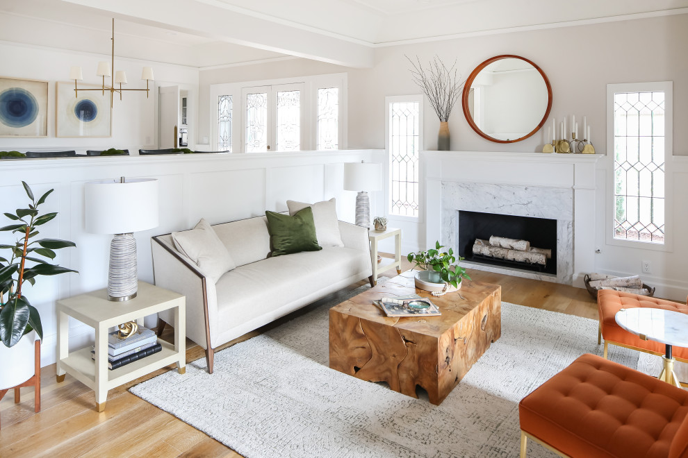 Inspiration for a coastal light wood floor living room remodel in Orange County with a stone fireplace