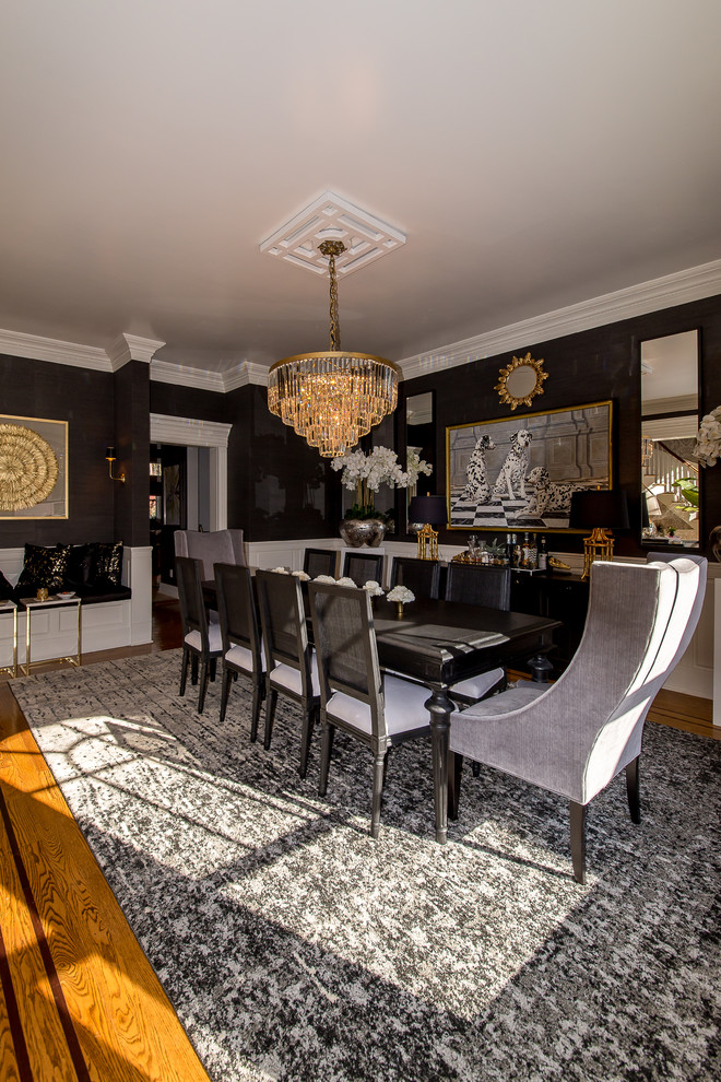 Traditional separate dining room in New York with black walls and medium hardwood floors.