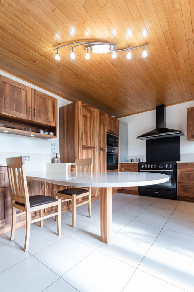 Large transitional u-shaped separate kitchen in Grenoble with an integrated sink, recessed-panel cabinets, medium wood cabinets, quartzite benchtops, white splashback, engineered quartz splashback, panelled appliances, ceramic floors, white floor, white benchtop and timber.