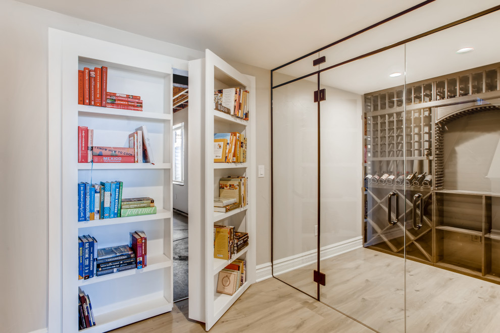 Photo of a mid-sized contemporary wine cellar in Denver with vinyl floors, display racks and brown floor.