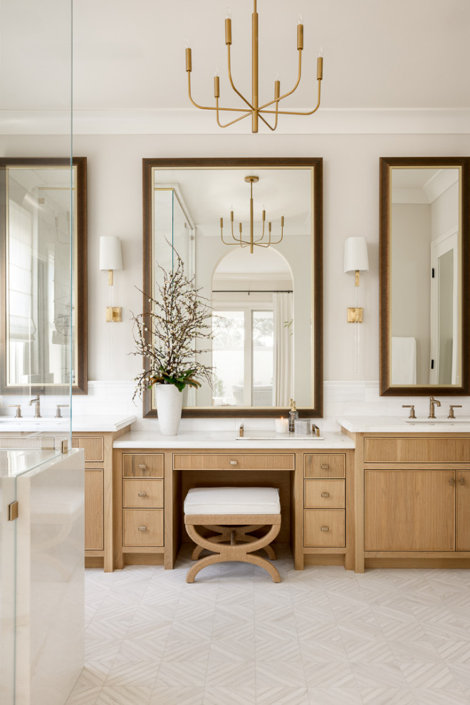 Inspiration for a large traditional ensuite bathroom in Orange County with light wood cabinets, a freestanding bath, a built-in shower, a one-piece toilet, white tiles, marble tiles, white walls, mosaic tile flooring, a submerged sink, marble worktops, white floors, a hinged door, white worktops, double sinks, a built in vanity unit and beaded cabinets.