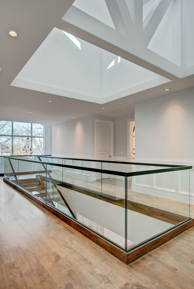 Example of a transitional glass straight open staircase design in Calgary