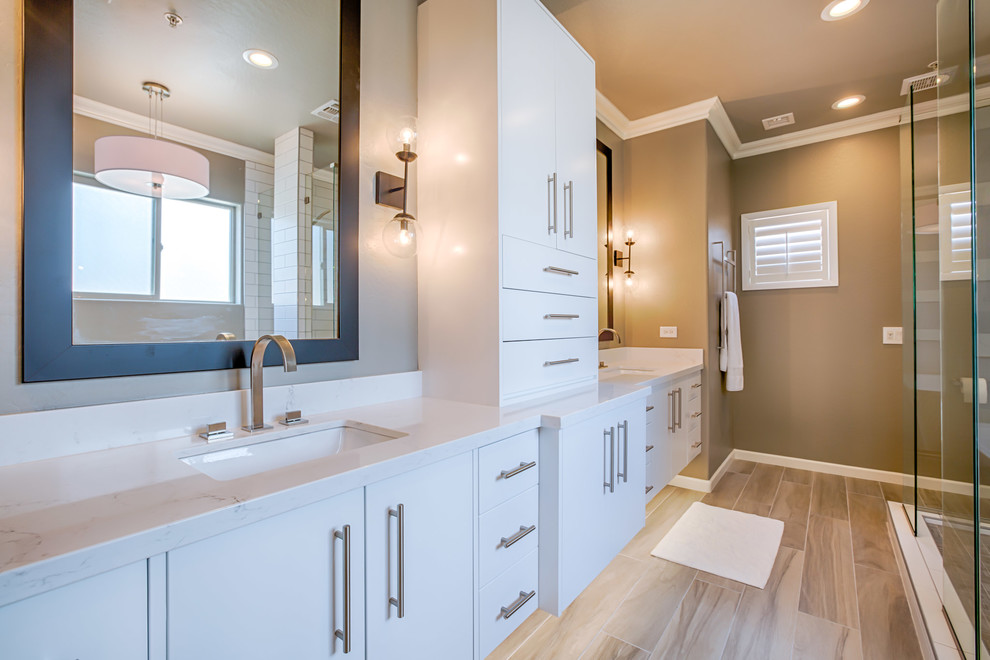 Design ideas for a large modern master bathroom in Phoenix with flat-panel cabinets, white cabinets, a freestanding tub, an open shower, a one-piece toilet, white tile, subway tile, grey walls, porcelain floors, an undermount sink, quartzite benchtops, grey floor and an open shower.
