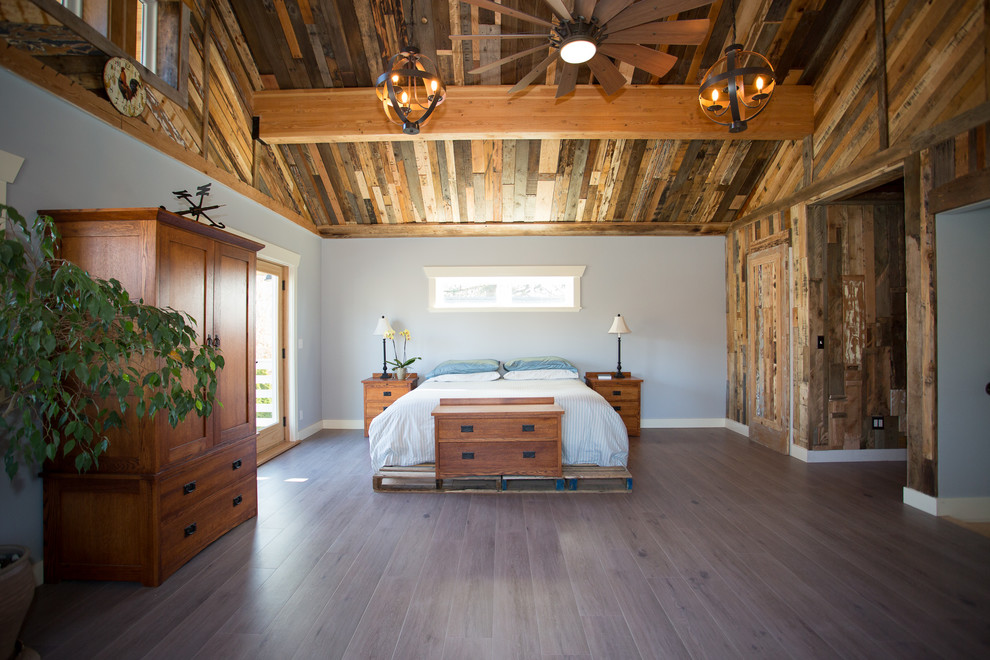 Mid-sized country guest bedroom in Seattle with grey walls, dark hardwood floors, no fireplace and brown floor.