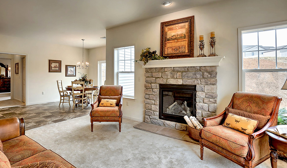 Inspiration for a mid-sized traditional enclosed living room in Philadelphia with beige walls, carpet, a standard fireplace and a stone fireplace surround.
