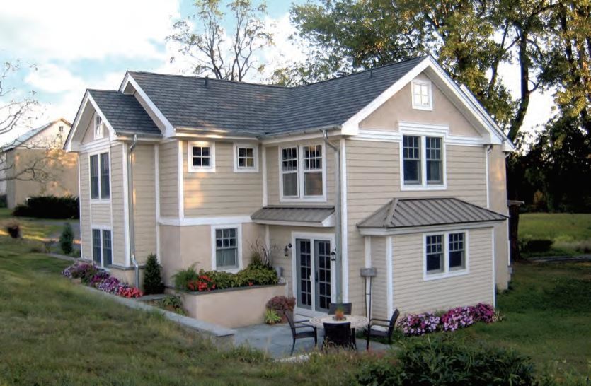 Large country two-storey beige exterior in Other with mixed siding and a gable roof.