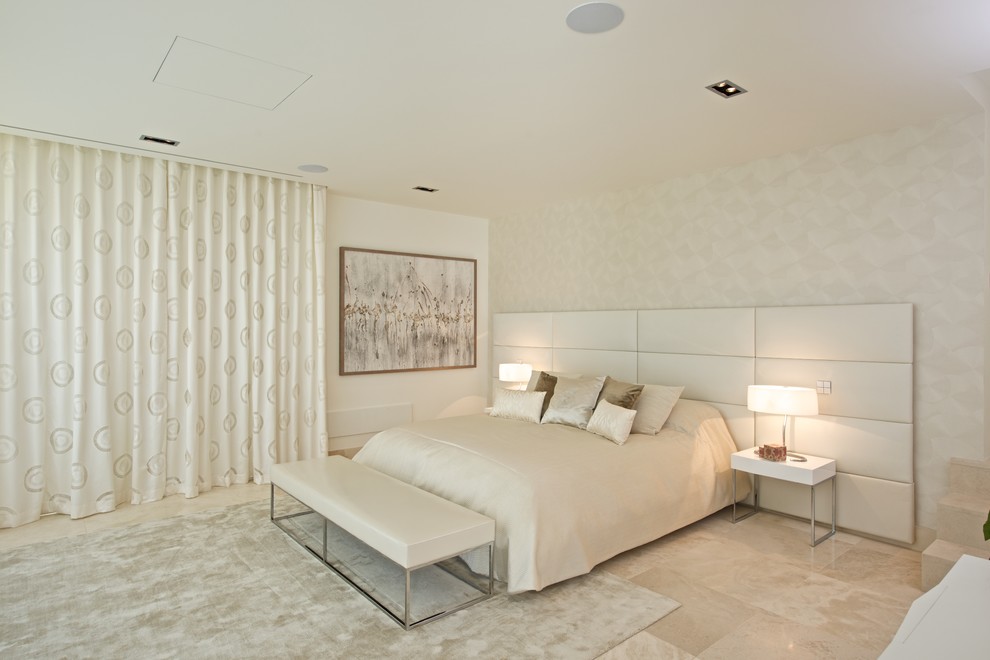 This is an example of a large transitional master bedroom in Palma de Mallorca with beige walls, marble floors and no fireplace.
