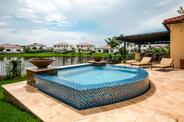 Swim Spa With Custom Fire Bowls and Outdoor Kitchen in Cooper City, Florida modern-swimming-pool