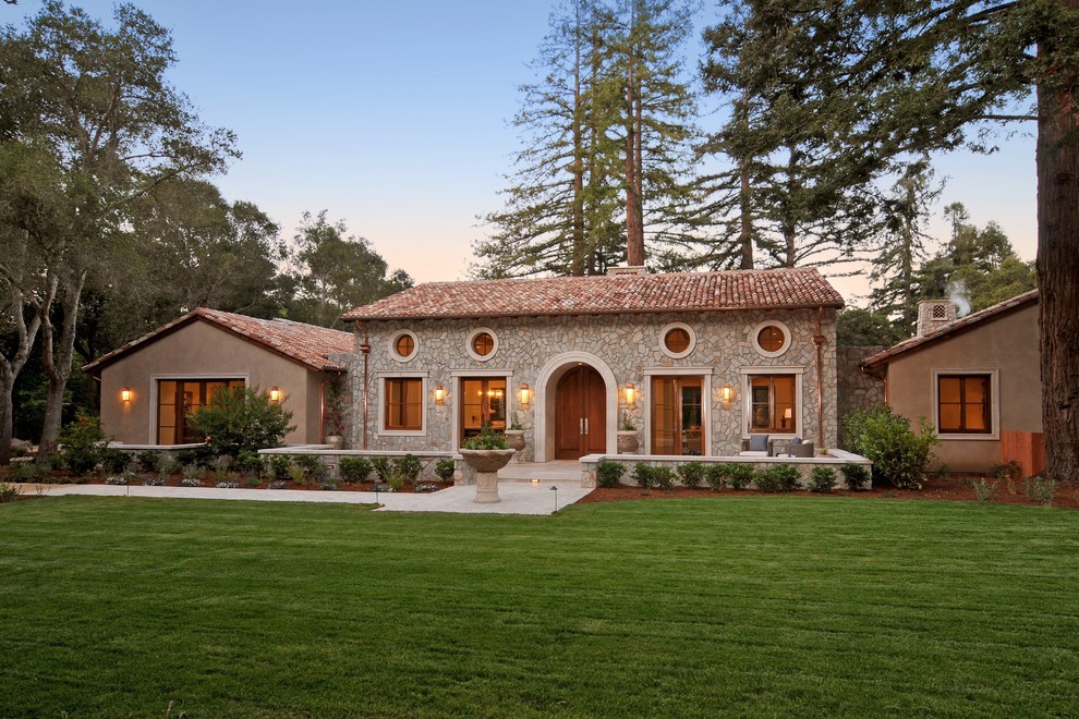 Mediterranean one-storey beige exterior in San Francisco with stone veneer and a gable roof.
