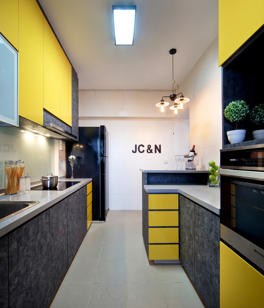 Inspiration for a contemporary galley kitchen in Singapore with a drop-in sink, flat-panel cabinets and yellow cabinets.