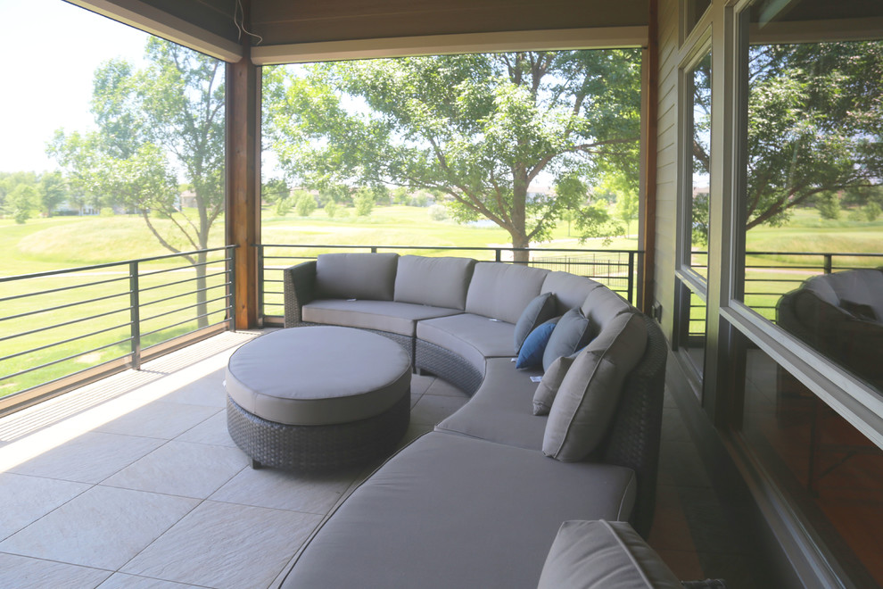 Inspiration for a mid-sized transitional backyard deck remodel with a roof extension