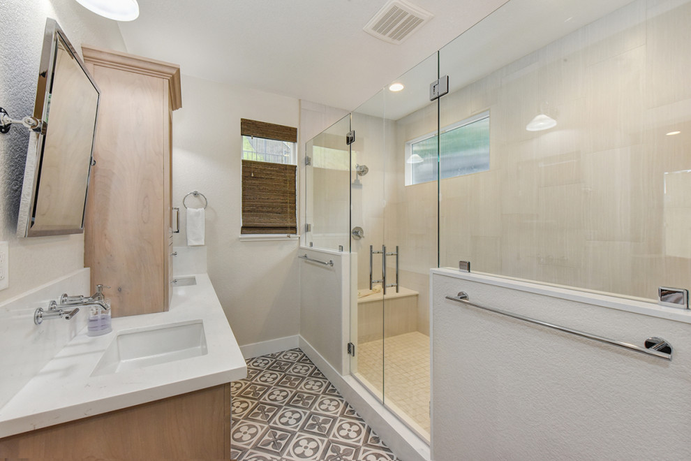 This is an example of a mid-sized modern master bathroom in Sacramento with recessed-panel cabinets, light wood cabinets, a double shower, a one-piece toilet, white tile, white walls, an undermount sink, engineered quartz benchtops, multi-coloured floor, a hinged shower door, white benchtops, a shower seat, a double vanity and a freestanding vanity.