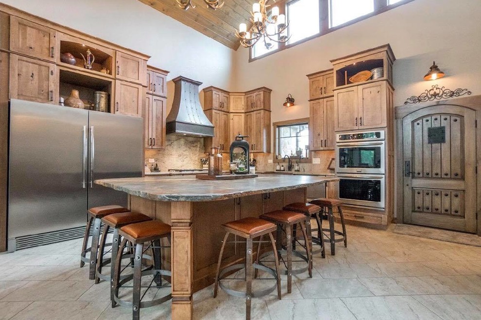 Inspiration for a large rustic l-shaped eat-in kitchen remodel in Chicago with a farmhouse sink, granite countertops, beige backsplash, stone slab backsplash, stainless steel appliances, an island and beige countertops