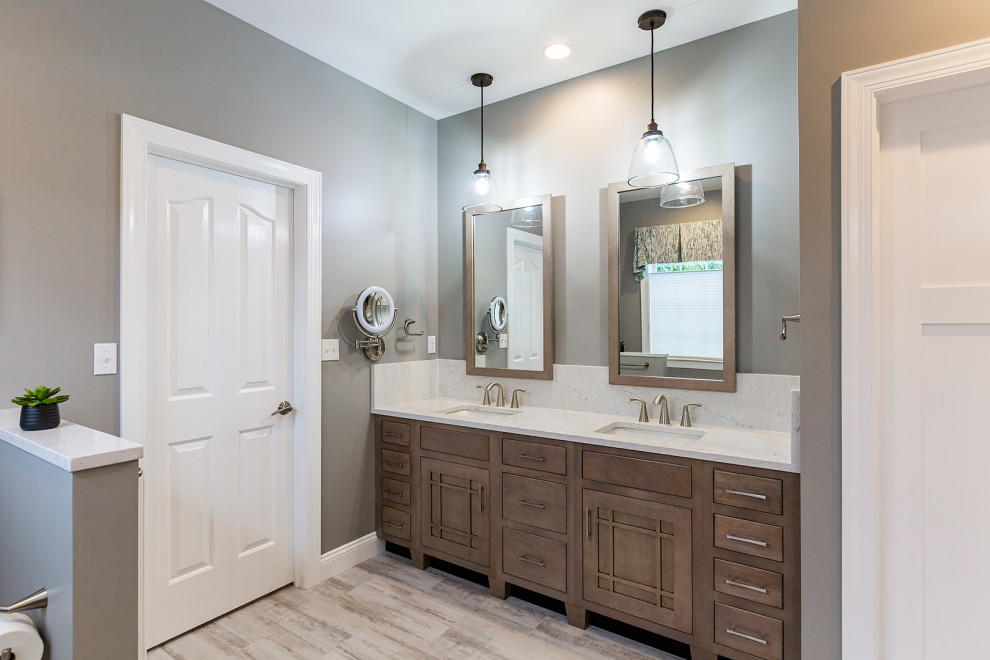 Photo of a large modern master bathroom in Other with flat-panel cabinets, medium wood cabinets, a corner shower, a two-piece toilet, white tile, stone slab, brown walls, wood-look tile, an undermount sink, quartzite benchtops, multi-coloured floor, a hinged shower door, white benchtops, a shower seat, a double vanity and a built-in vanity.