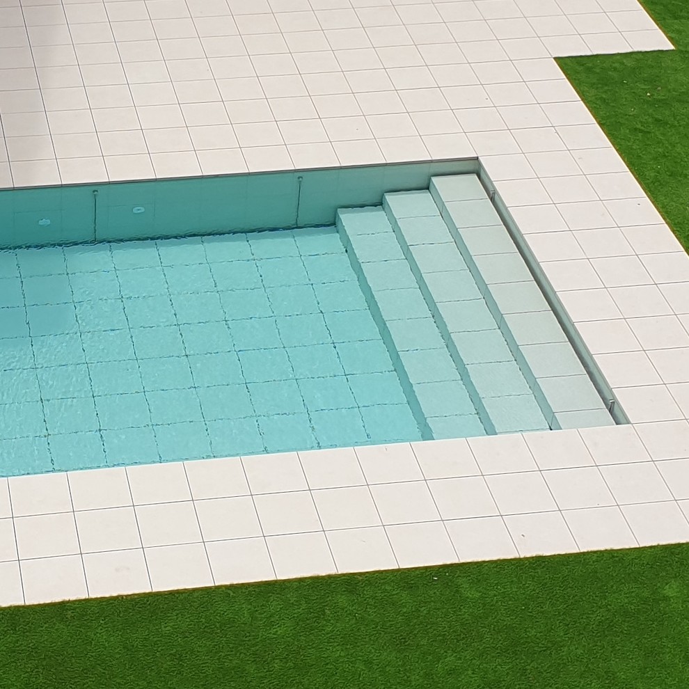 This is an example of a mid-sized modern custom-shaped lap pool in Barcelona with tile.