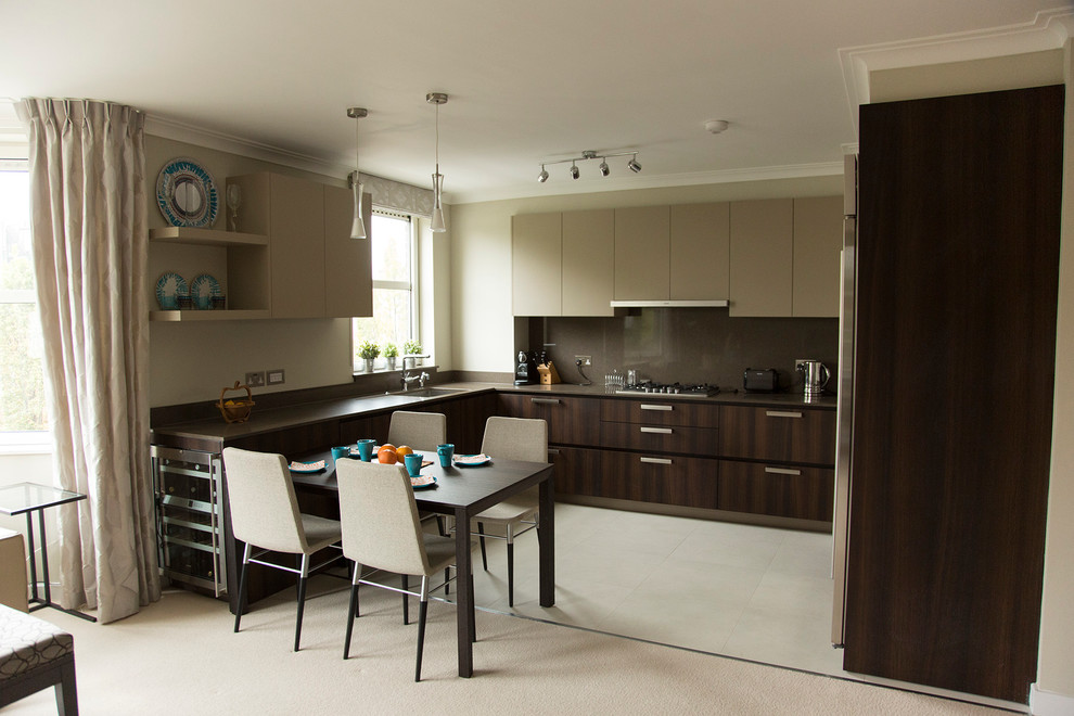 This is an example of a mid-sized contemporary u-shaped eat-in kitchen in London with an undermount sink, flat-panel cabinets, dark wood cabinets, quartz benchtops, brown splashback, stainless steel appliances, ceramic floors and no island.