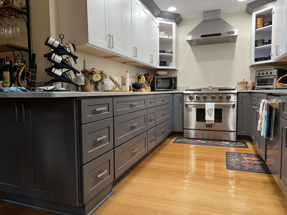 Photo of a small galley kitchen/diner in Jacksonville with a submerged sink, recessed-panel cabinets, grey cabinets, quartz worktops, grey splashback, engineered quartz splashback, stainless steel appliances, light hardwood flooring, a breakfast bar, beige floors, white worktops and a coffered ceiling.